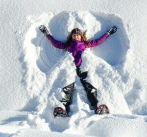 Child making snow angel